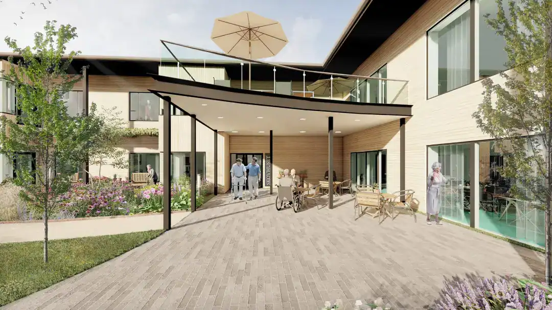 Udendørs terrasse på moderne boligkompleks med balkon og grønne omgivelser.